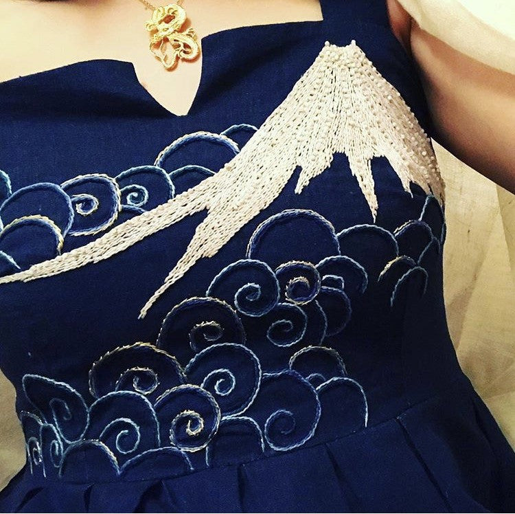 Hand embroidered Mt Fuji and clouds on a hand made dress and gold Hokusai dragon necklace by Tarra Rosenbaum