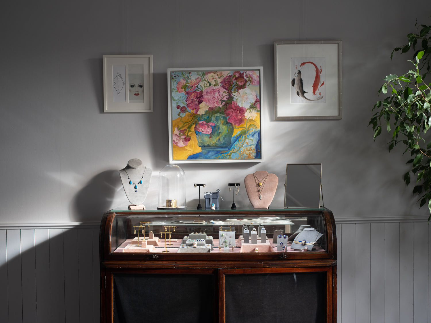 Handcrafted Jewellery London, photo of the studio display with artwork over the display of the jewellery. 