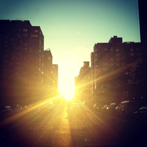 Summer solstice sunset in NY city between the streets