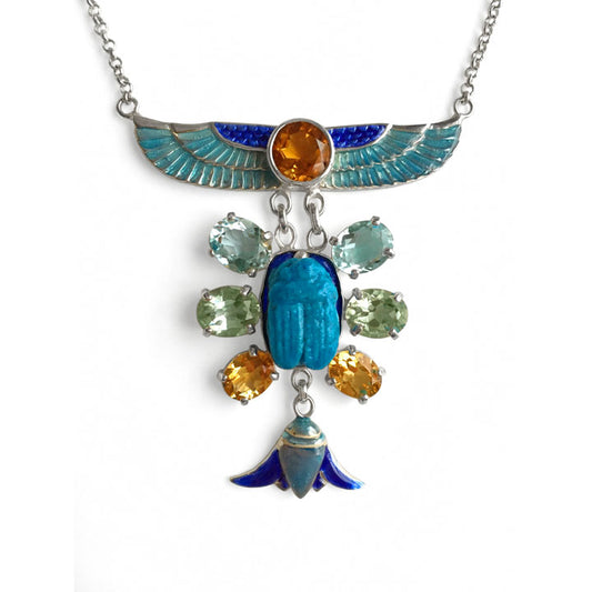 Enamel Egyptian Wings radiate from a citrine and transition to a turquoise Faience scarab with three stones radiating out, citrine, prasiolite, aqua marine 
