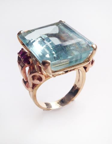 Large aqua marine with rubies set in rose gold as a ring