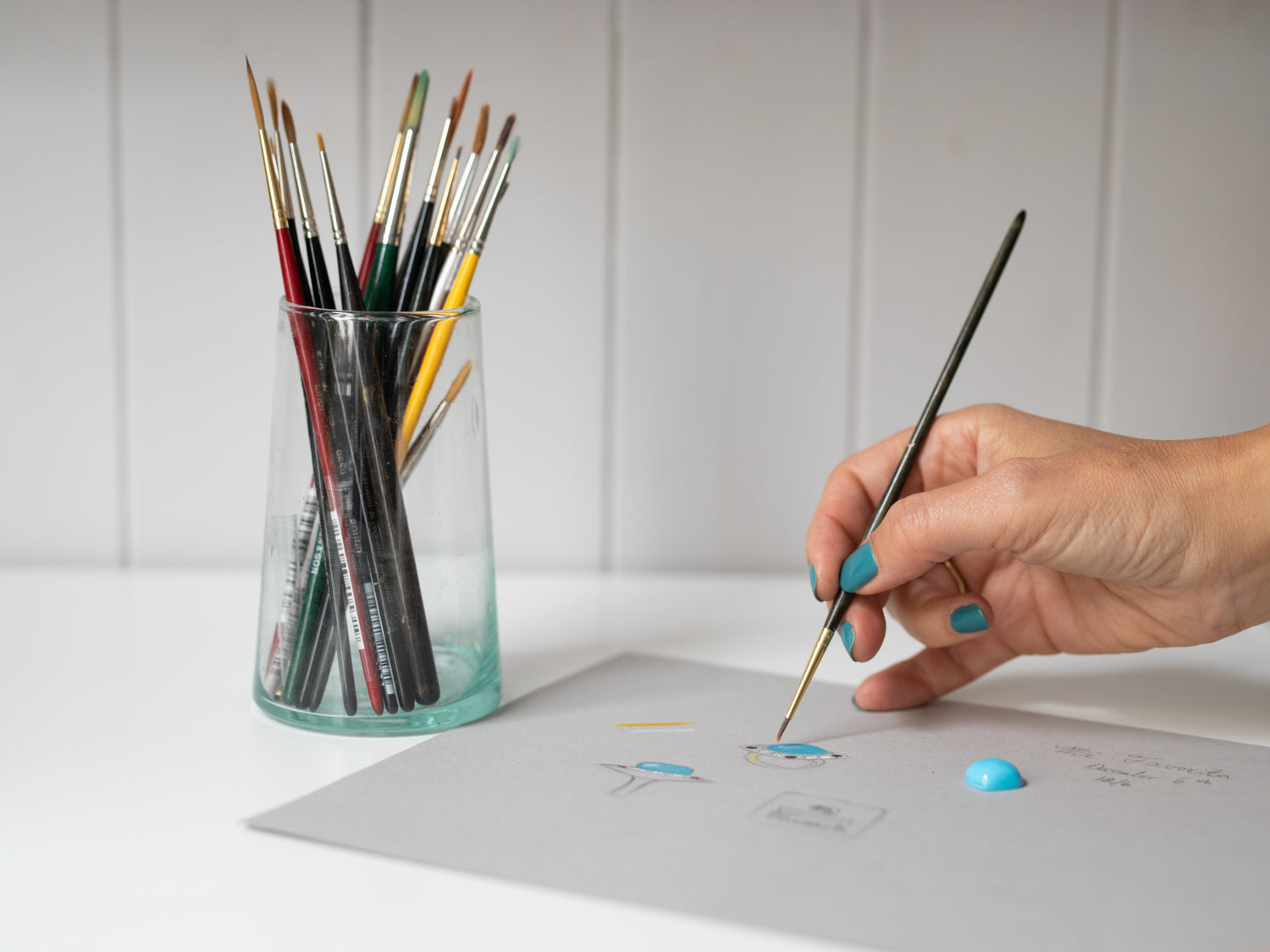 Custom Jewellery London. Tarra Rosenbaum's hand painting a custom design with brushes and a turquoise cabochon stone.